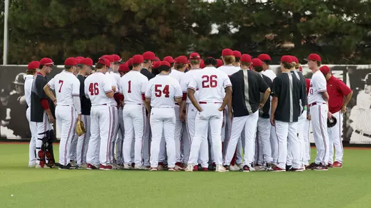 The Cardinals huddle in the outfield.