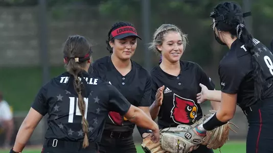 Softball huddle vs Bellarmine in the fall