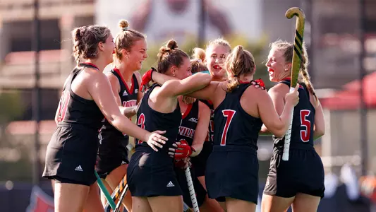 The field hockey team celebrates the win against JMU
