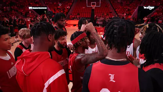 A photo of the men's basketball team huddling before the 2022 Red and White Scrimmage.