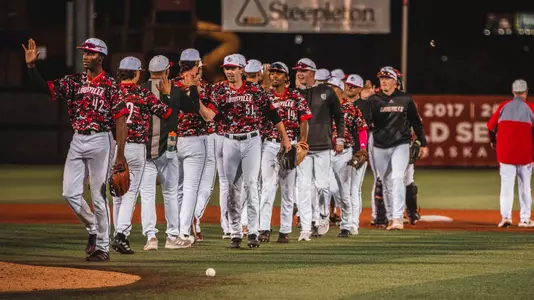 The Cardinals high five after a Pizza Bowl game.