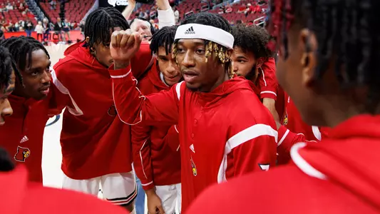 El Ellis directs the men's basketball team huddle before an exhibition game against Lenoir-Rhyne.