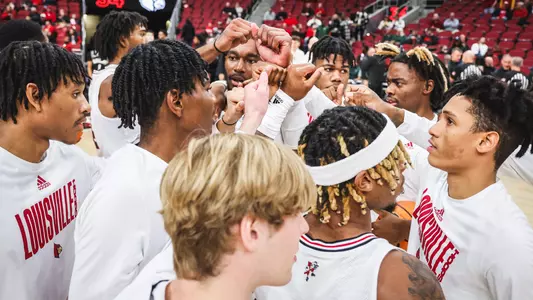 The Louisville men's basketball team huddles before a game against Wright State.