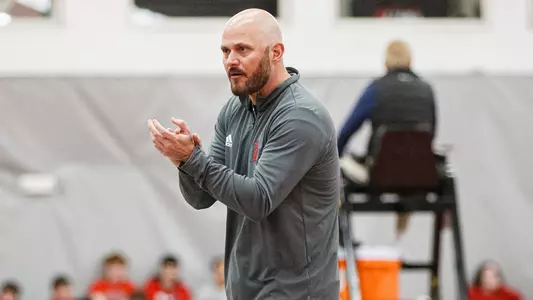 Men's tennis coach Rodrigo da Silva cheers his team on
