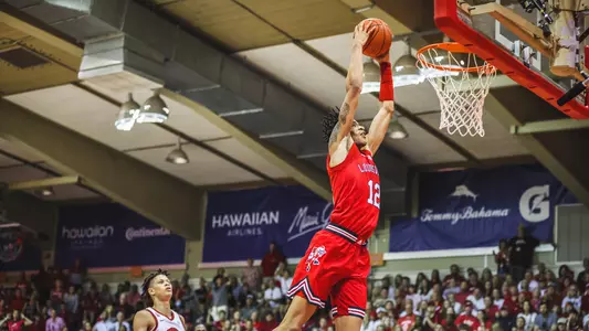 JJ Traynor dunks the ball on the fast break against Arkansas at the Maui Invitational.