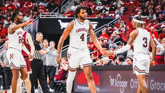 Roosevelt Wheeler celebrates with El Ellis during a play against Bellarmine at the KFC Yum! Center.