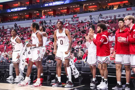 The Louisville men's basketball bench reacts to a play during an exhibition game against Chaminade.