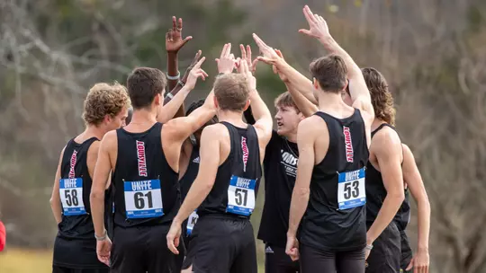 Louisville men break the huddle at the ACC Championships.