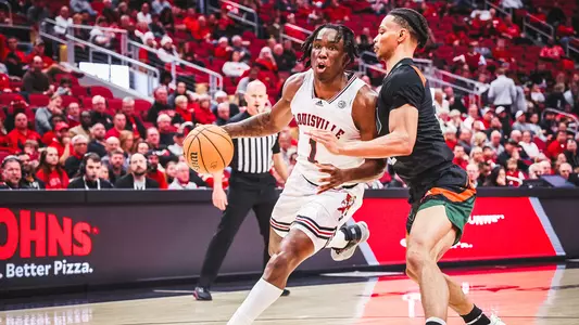 Mike James drives against Miami at the KFC Yum! Center on Dec. 4, 2022.