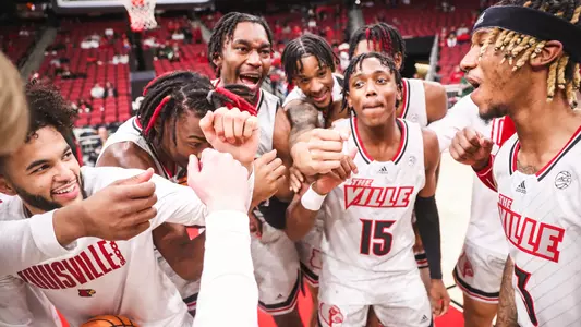 The Louisville men's basketball team huddles before the game against Western Kentucky on Dec. 14, 2022.