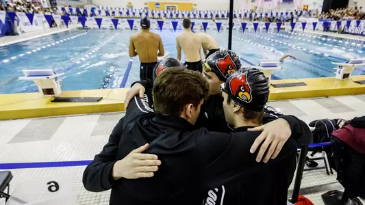 The men's 800 free relay team huddles before the race