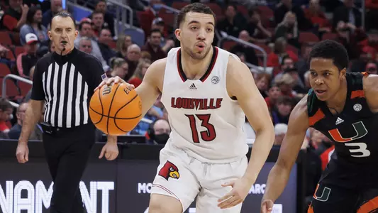 Jarrod West drives against Miami in the KFC Yum! Center on Feb. 16, 2022.