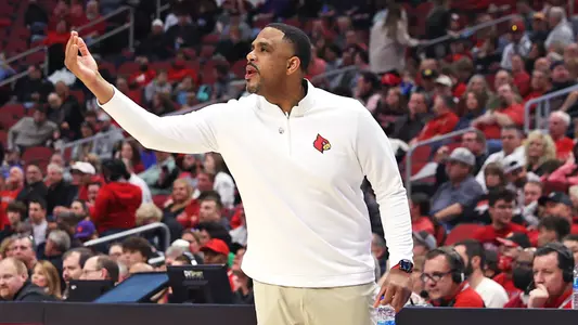 UofL interim head coach Mike Pegues motions to his team in the KFC Yum! Center against Clemson on Feb. 19, 2022.