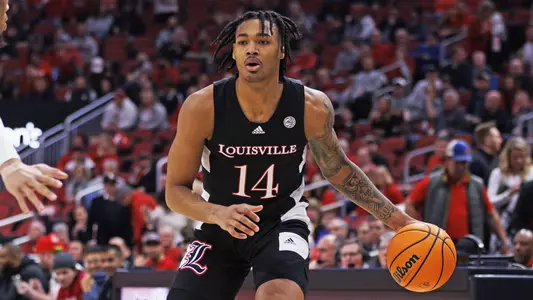 Dre Davis surveys the Clemson defense in the KFC Yum! center on Feb. 19, 2022.