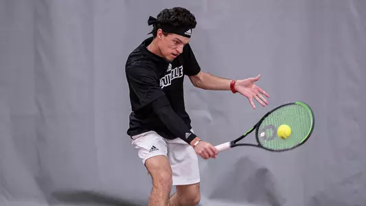 Matthew Fung returns a serve