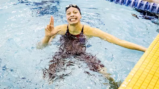 Liberty Williams smiles as she looks at her finish time