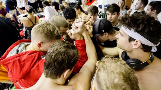 The men's team huddles before the championship
