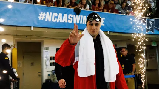 Nick Albiero walks through fireworks en route to finals