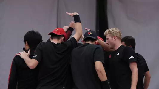Louisville Men's Tennis team huddles before match
