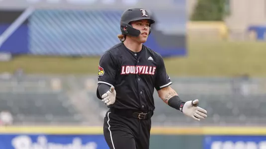 Louisville's Dalton Rushing rounds the bases after hitting a home run against Pitt.
