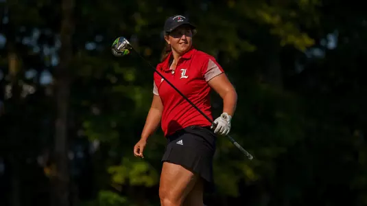 Lauren Thibodeau walks toward golf bag