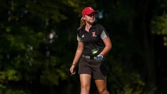 Molly Lyne walks toward bag after a drive