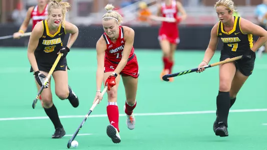 Rylie Wollerton dribbles the ball between to Iowa defenders