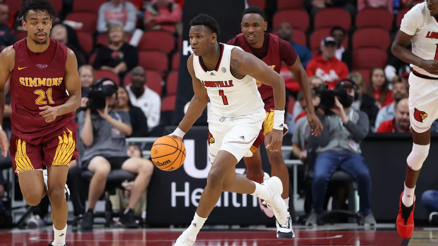 Curtis Williams drives the ball up the court against Simmons College on Oct. 18, 2023.