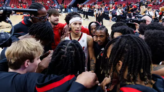 Louisville men's basketball players huddle before playing Simmons College in an exhibition game on Oct. 18, 2023.