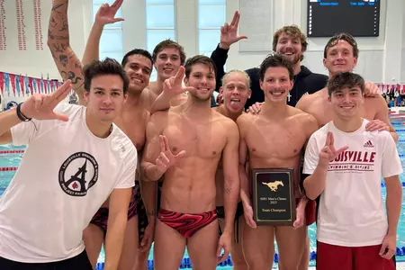 Swimmers pose with trophy for SMU Classic win