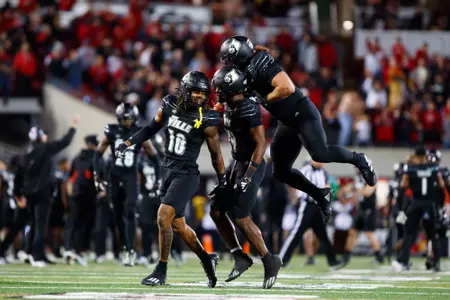 Benjamin Perry, Storm Duck, and Ashton Gillotte celebrate during Louisville vs Virginia Football Game
