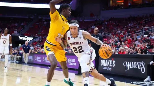 Tre White drives the ball against Chattanooga at the KFC Yum! Center on Nov. 10, 2013.