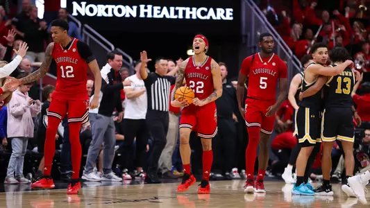 Tre White celebrates during Louisville men's basketball's victory over UMBC.