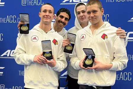 200 medley relay team on the podium with their bronze medals