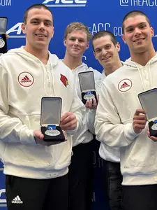 The 800 Free Relay team poses on the podium with their silver medals