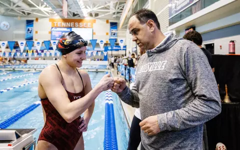 Arthur Albiero fist bumps Abby Hay for her school record in the 200 IM