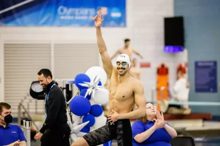 Abdelrahman El-Araby smiles at the crowd from the blocks