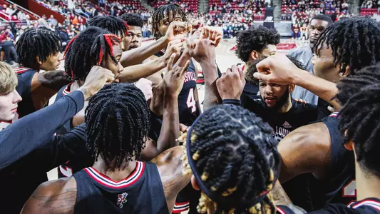 Louisville men's basketball players huddle before a game at Boston College on Jan. 25, 2023.