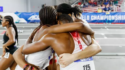 Women's 4x400m relay team huddles after taking third at the ACC Indoor Championships