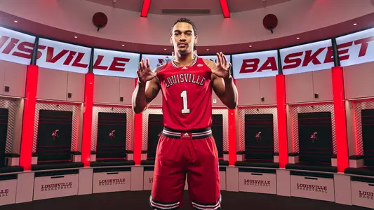 New Louisville men's basketball transfer guard Skyy Clark poses in the Cardinals' locker room.