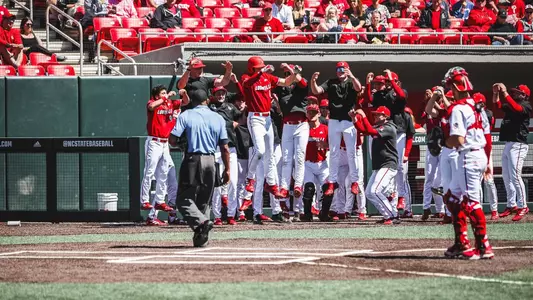 The Cardinals celebrate a Patrick Forbes home run at NC State.