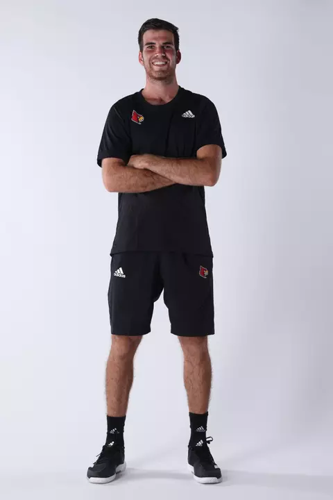 David Mizrahi poses while standing in front of a white backdrop.