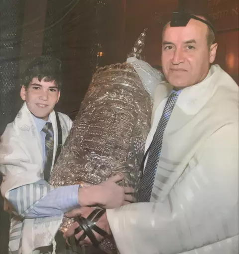 David Mizrahi and his father getting the honor of carrying and escorting the Torah to be read at David's Bar Mitzvah