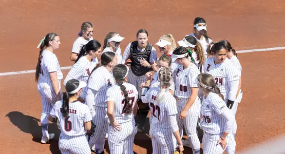 Louisville softball huddle in the ACC quarterfinal game against Virginia Tech