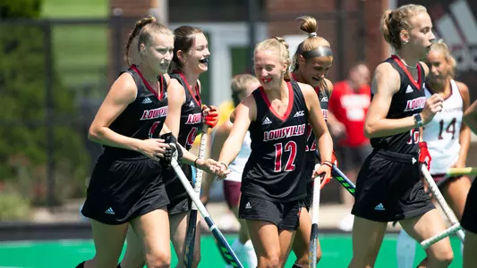 Louisville field hockey team celebrates a goal against Bellarmine