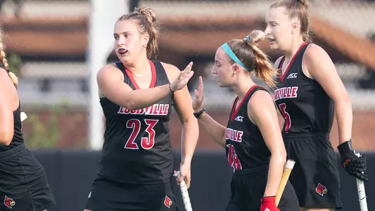 Louisville field hockey celebrates a goal in the scrimmage against Bellarmine