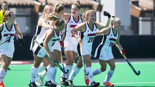 UofL field hockey celebrates a goal against VCU