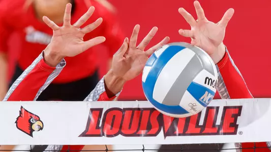 Hands blocking the ball at the net