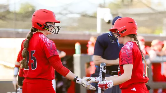 Maddi Grant and Madison Pickens meet at the plate during the fall softball game against Indiana