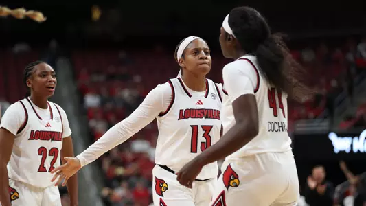Merrissah Russell and Olvia Cochran chest bump after a play